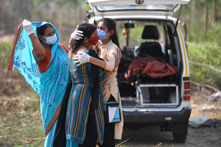 Relatives grieve as they arrive for the cremation of their loved one who died due to coronavirus, at a crematorium in Moradabad, Uttar Pradesh [Prakash Singh/AFP]