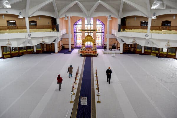 Members of the Indian diaspora community attending private prayer at a Sikh temple in Southall.