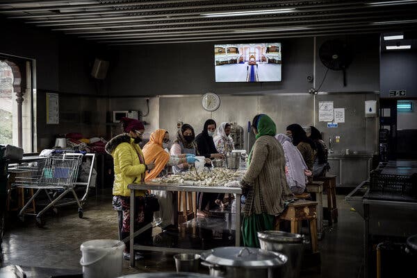 Members of the Indian diaspora community in Southall prepare food in a communal kitchen at a Sikh temple.