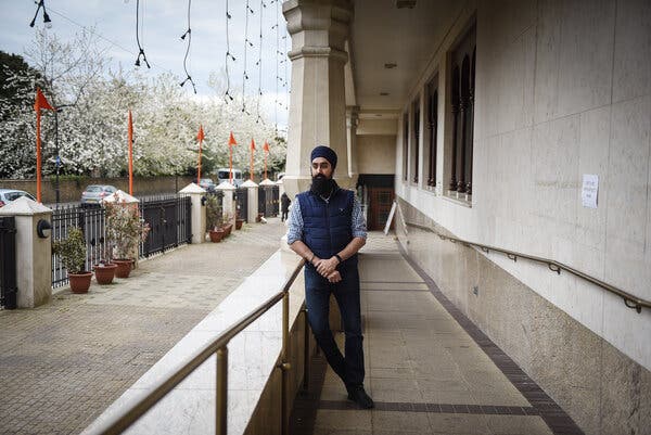 Harmeet Gill posing at a Sikh temple where he volunteers in the London borough of Southall.