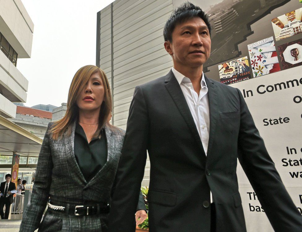 City Harvest Church founder Kong Hee (R) arrives with his pop-singer wife Ho Yeow Sun (L) at the district state courts